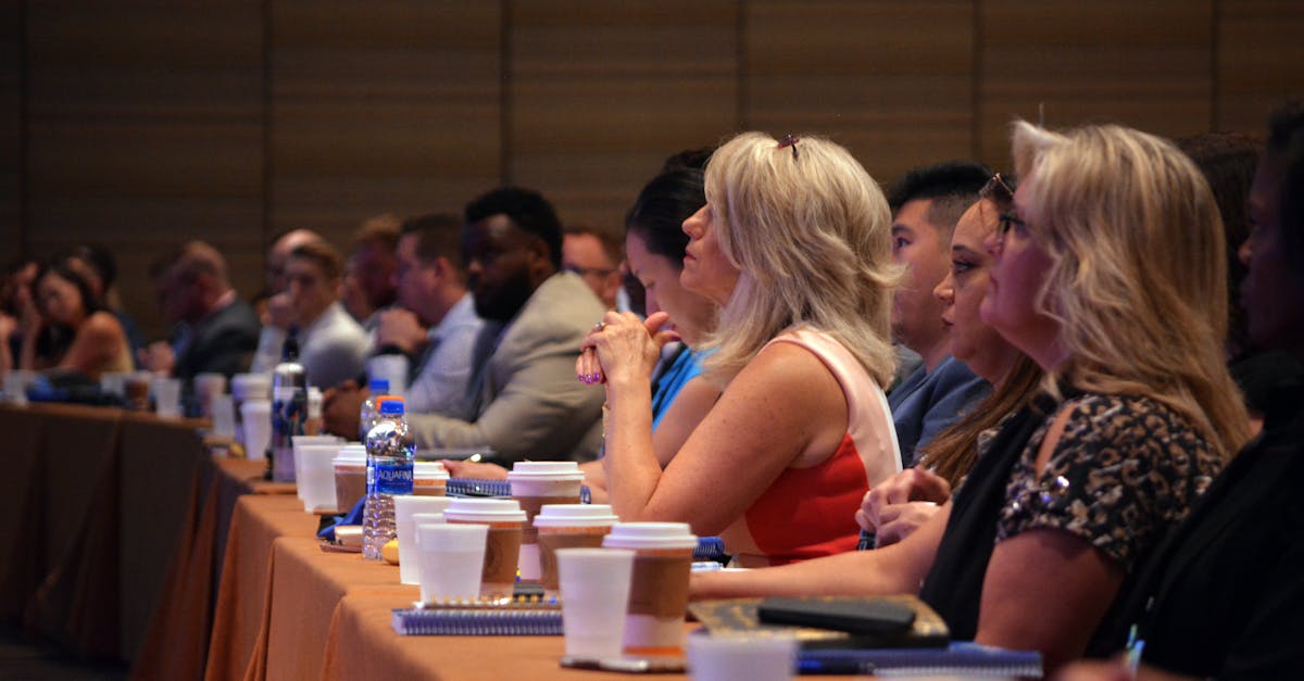 Diverse group of business professionals attentive during a conference session in a meeting room.