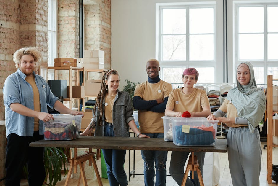 A diverse team of volunteers sorts clothing donations in an organized workspace, promoting community support.